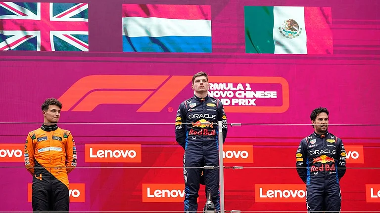 Winner Red Bull driver Max Verstappen of the Netherlands, center, listens to his national anthem flanked on the podium with second placed McLaren driver Lando Norris of Britain, left, and third Red Bull driver Sergio Perez of Mexico after the Chinese Formula One Grand Prix at the Shanghai International Circuit, Shanghai, China, Sunday, April 21, 2024.
- (AP Photo)